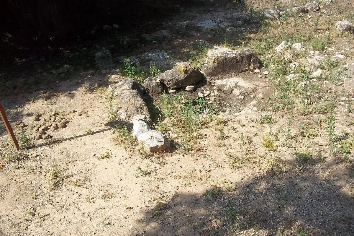 Ancient stones on the ground in the Kfar Saba Archaeological Garden on the old tel